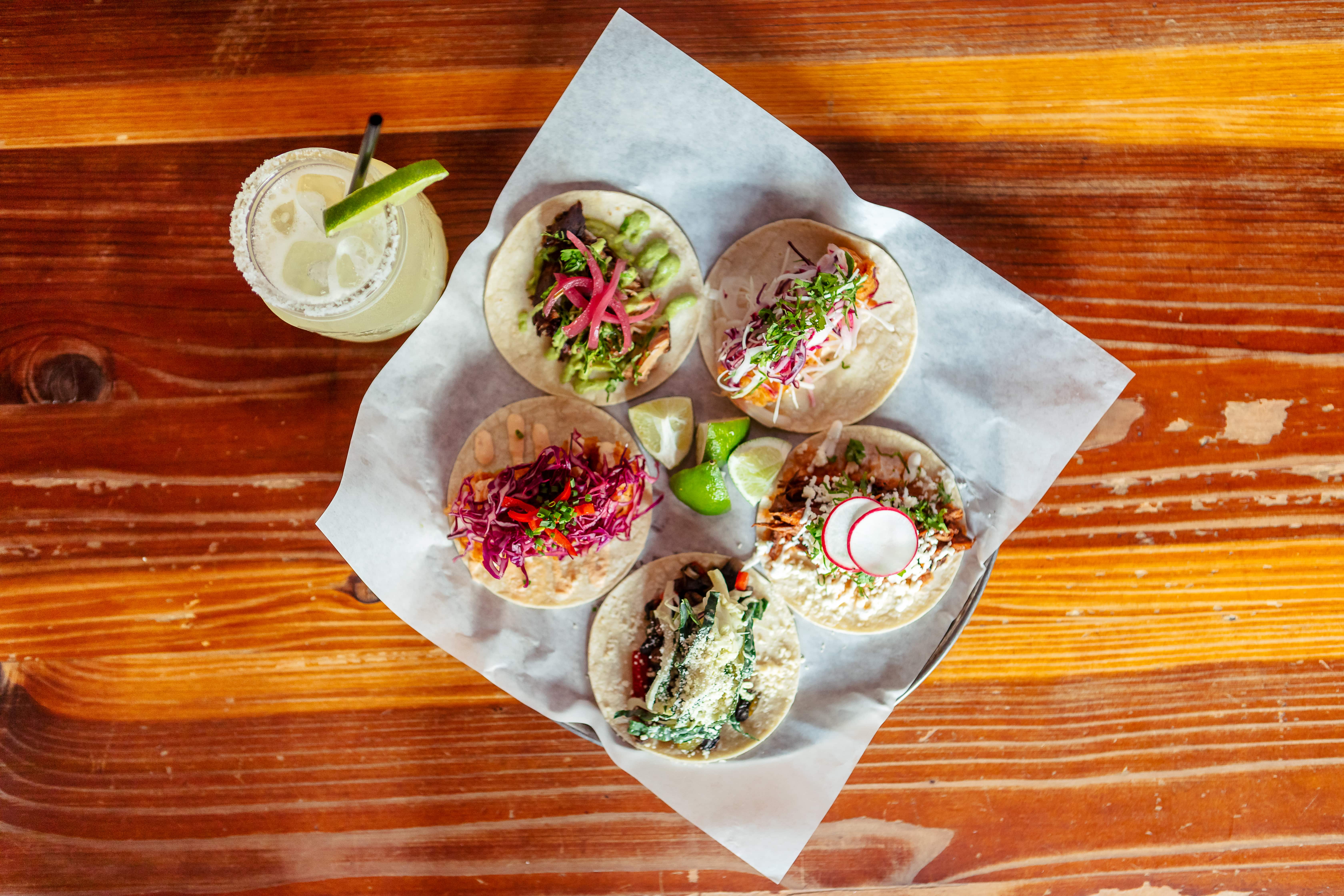 A plate of tacos and a margarita